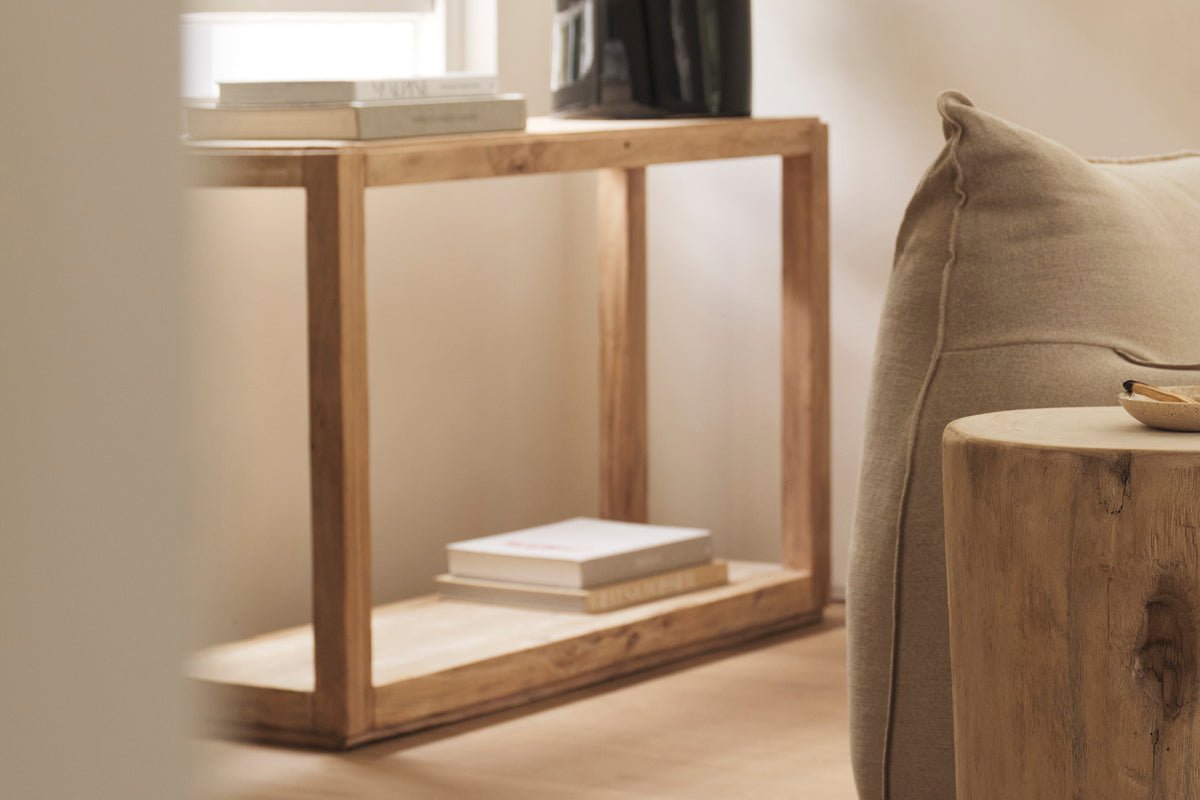 An old elm timber console table placed in a room with a neutral colour scheme.