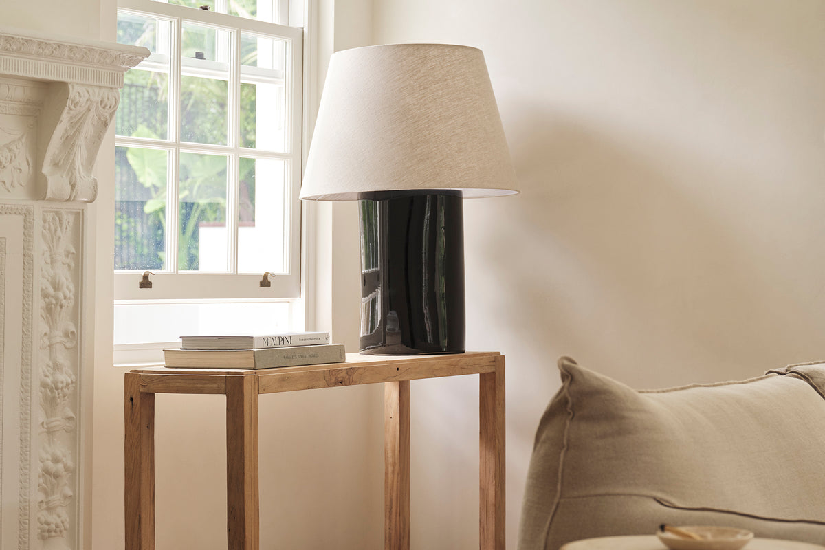 An old elm timber console table placed in a room with a neutral colour scheme.