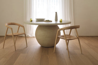 A modern dining chair made of ash timber, with a natural colour
