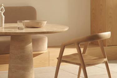 A modern dining chair made of ash timber, with a natural colour
