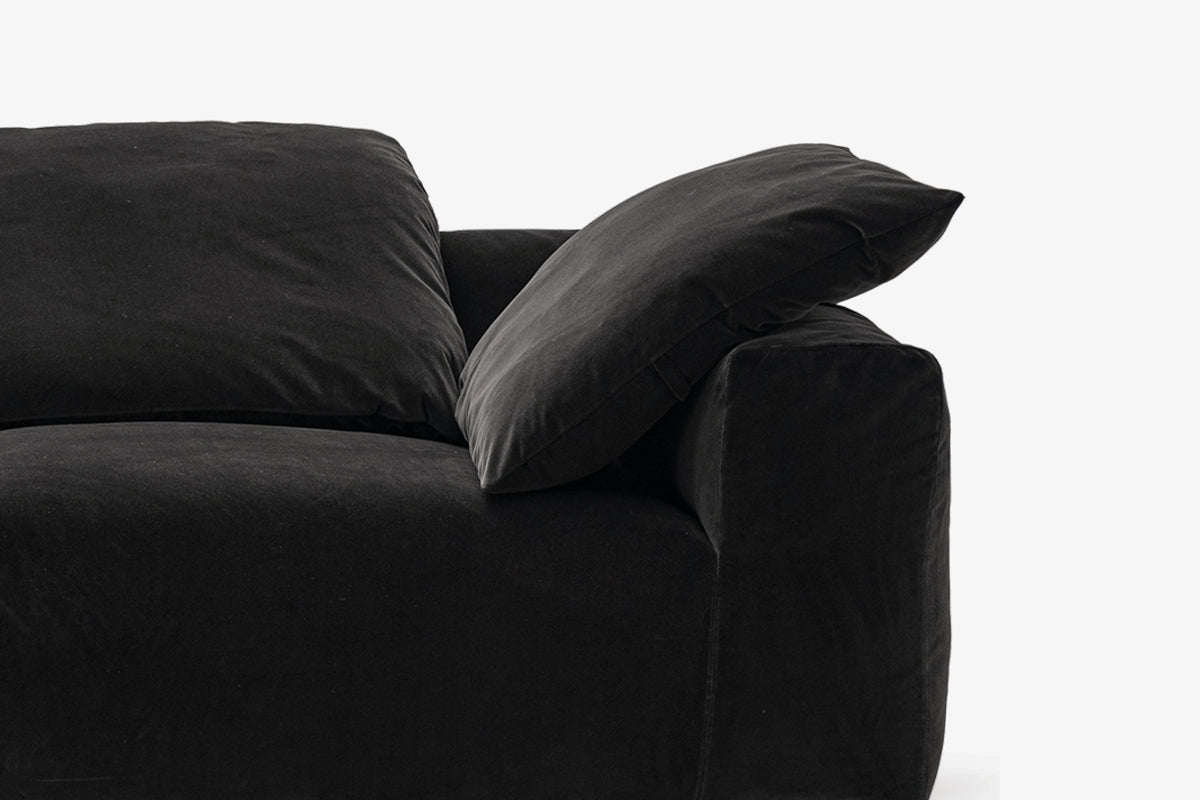 Close-up of black velvet sofa cushion and armrest