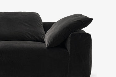 Close-up of black velvet sofa cushion and armrest