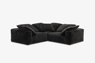 Black velvet corner nook sofa with three modules, studio front view