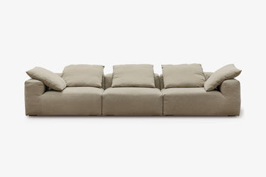 Taupe three-piece sofa with plush pillow back cushions, studio view