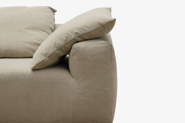 Close-up of taupe sofa arm and cushion, corner detail view