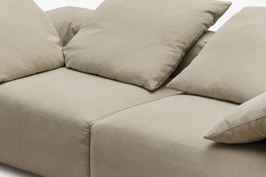 Close-up of taupe sofa back cushions with soft folds, side view