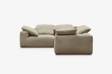 Taupe corner sofa with two angled modules, studio view