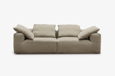 Taupe two-piece sofa with plush pillow back cushions, studio view