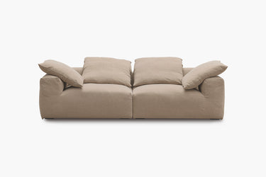 Warm taupe two-piece sofa with plush pillow back cushions, studio view