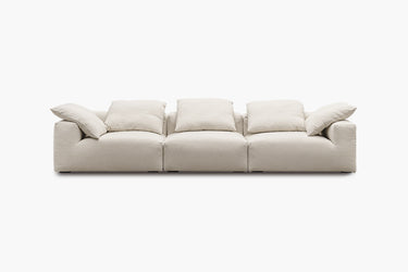 White three-piece sofa with plush pillow back cushions, studio view