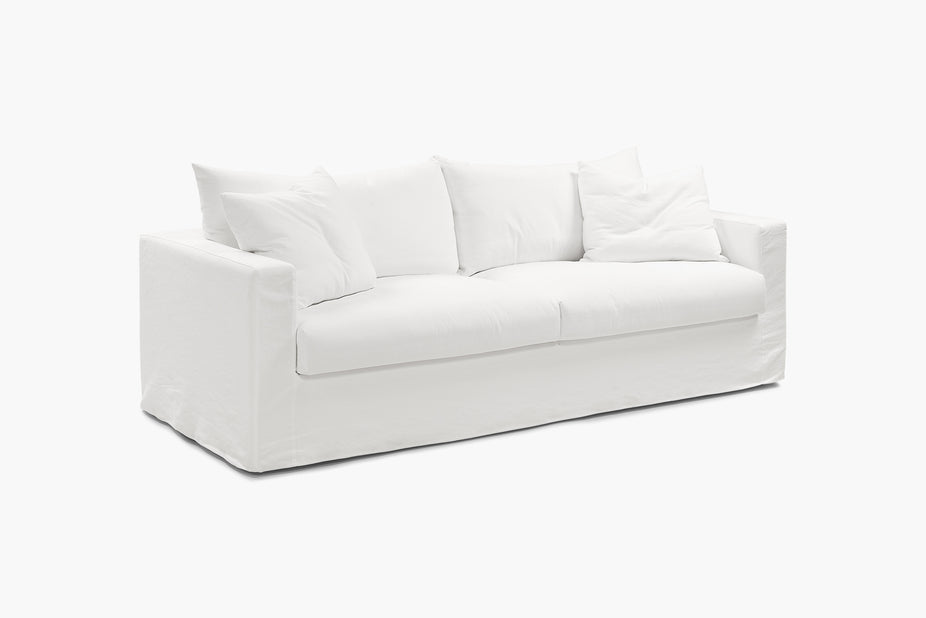 Close-up of a cream sofa back cushions from a high angle.