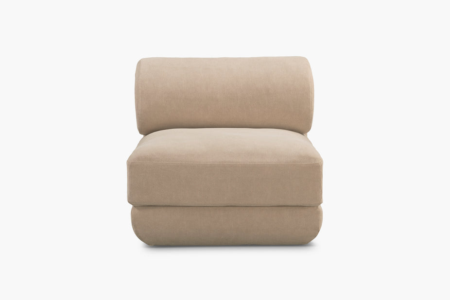 A modern low-profile accent chair upholstered in a textured beige fabric, shown from the front against a solid white background.