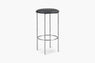 Backless bar stool with Black vinyl seat and metal legs on a white background.