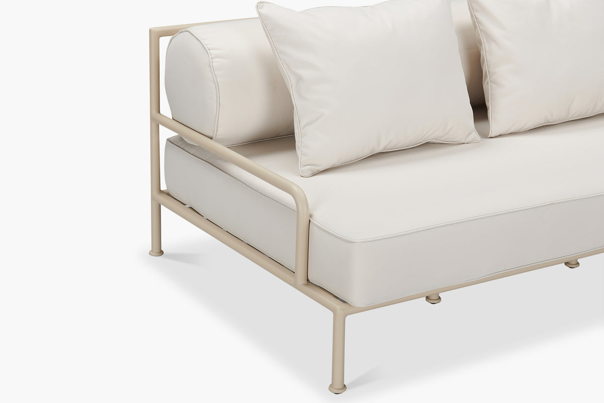 Close-up corner detail of cream outdoor sofa with pale aluminium frame