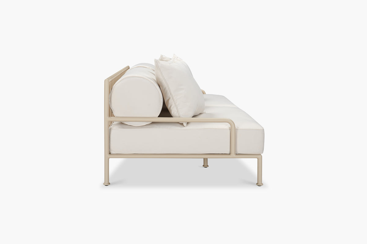 Cream outdoor sofa with pale frame, side view
