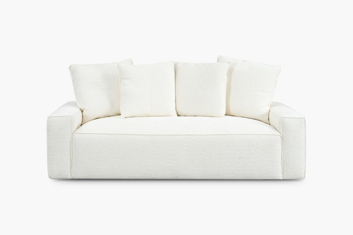White boucle sofa with four back cushions, studio front view