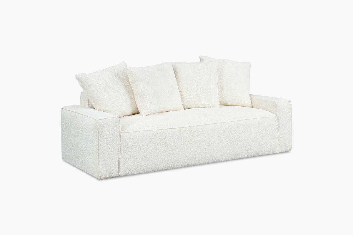 White boucle sofa with four back cushions, angled studio view