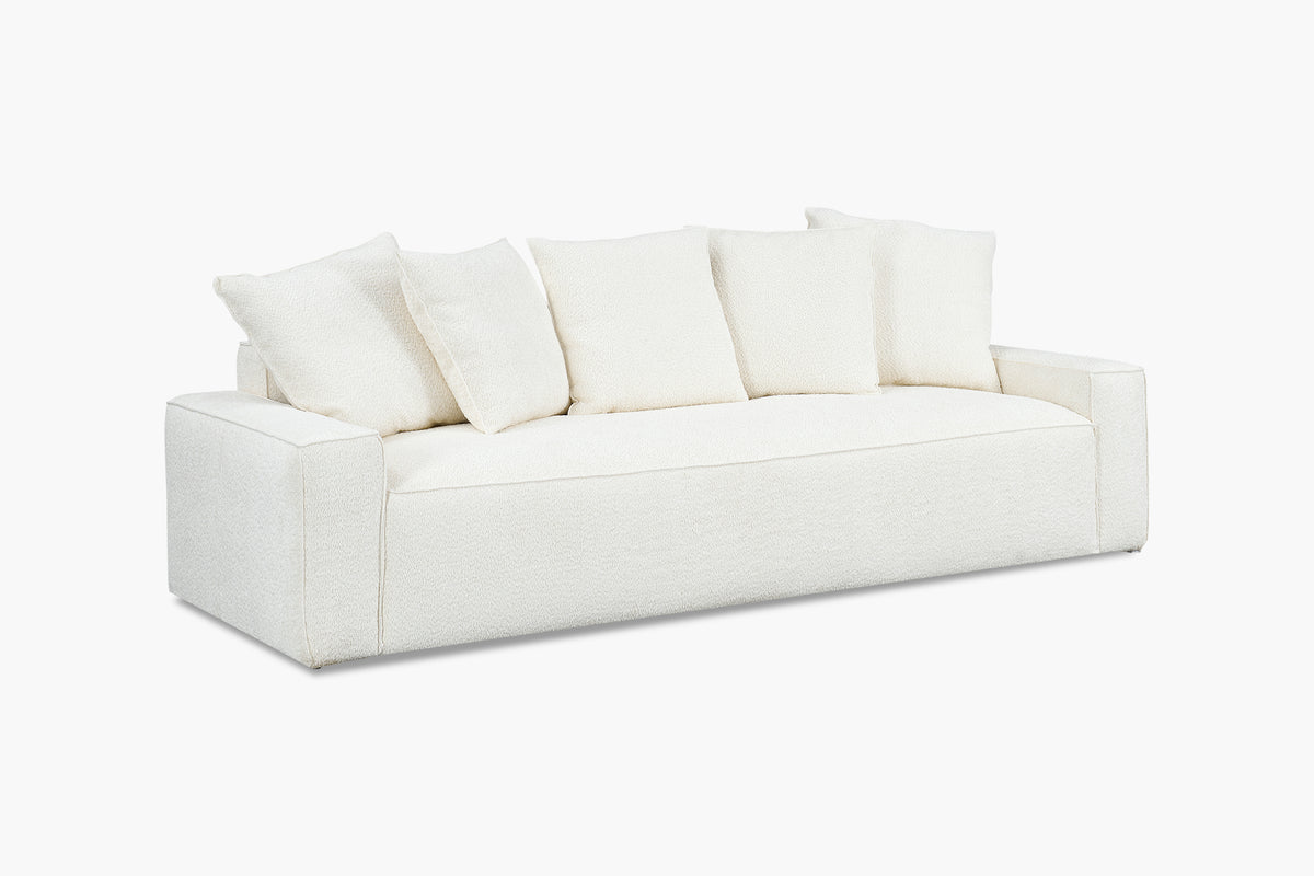 White boucle sofa with five back cushions, angled studio view