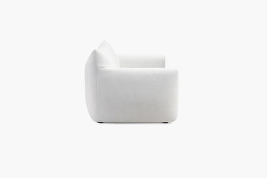 Side view of a white modular sofa showing its rounded arm and back cushion.