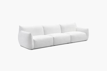 White three-piece modular sofa with rounded arms photographed at an angle.