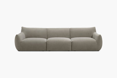Grey three-piece modular sofa with rounded arms shown from the front in a studio.