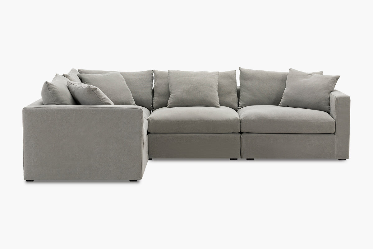Grey corner sofa with four-piece configuration, studio front-angled view