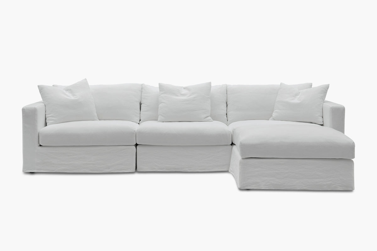 White corner sofa with chaise, three-piece configuration, studio angled view