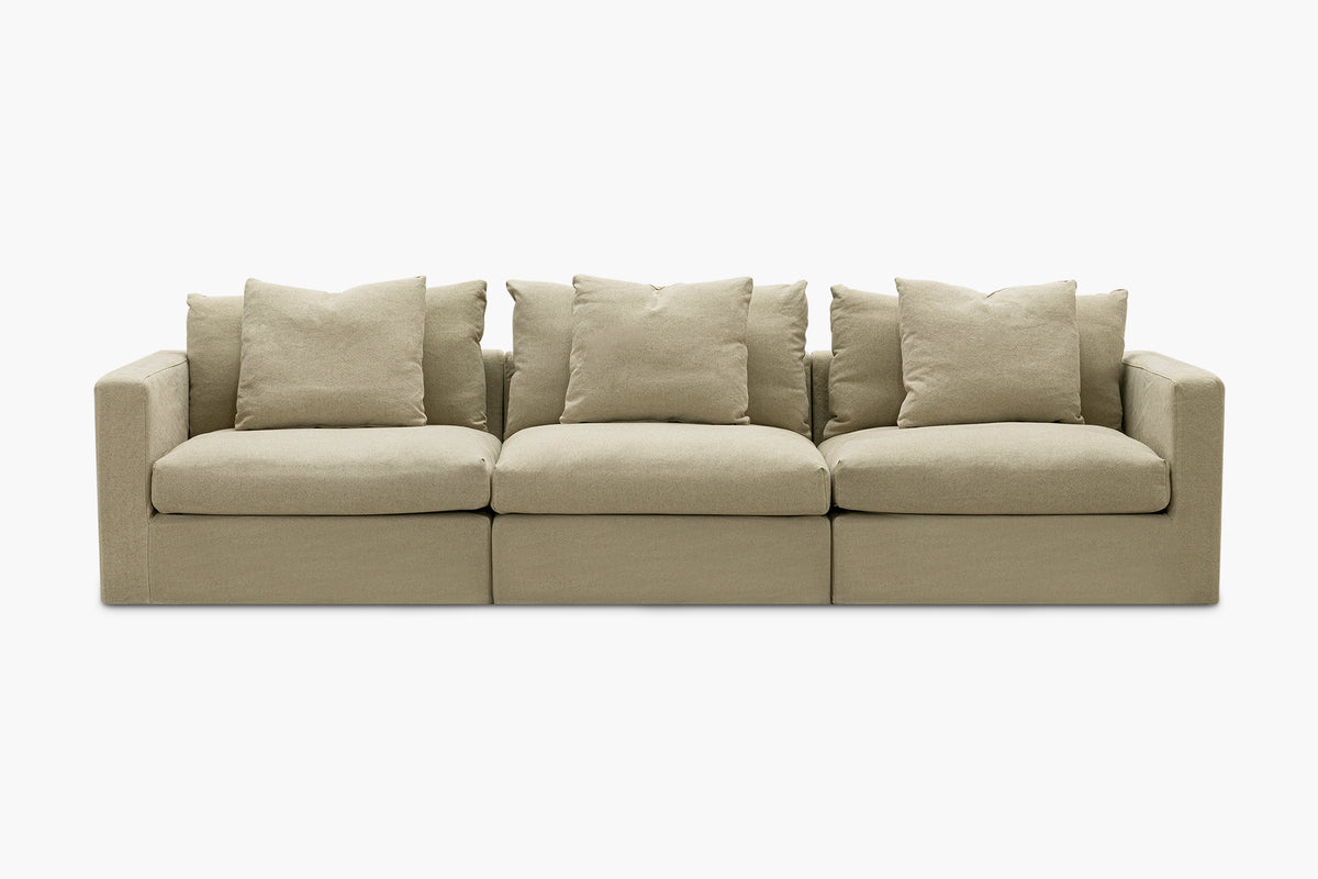 Beige linen three-seat sofa with six back cushions, studio front view