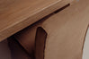 Close-up detail of a brown chair back meeting a light oak wood tabletop, showing the texture and edge of the furniture.