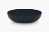 A minimalist, matte-black Coffee Table shown from a side angle against a clean white background.