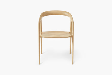 A modern dining chair with a solid ash timber frame.