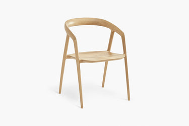 A modern dining chair with a solid ash timber frame.
