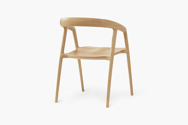 A modern dining chair with a solid ash timber frame.
