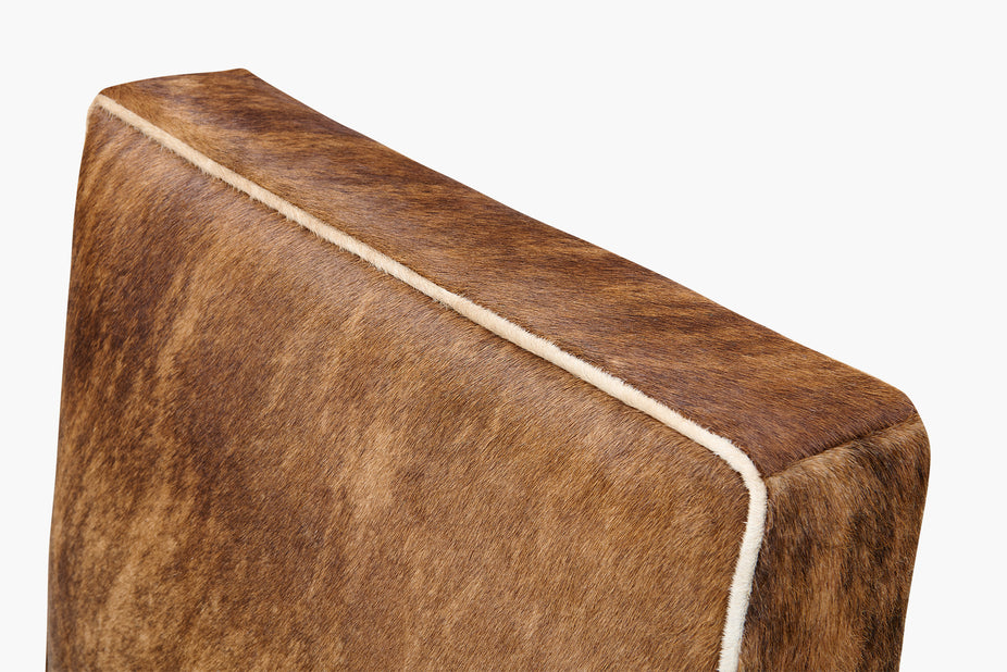 Brown cowhide chair with a white border on a white background