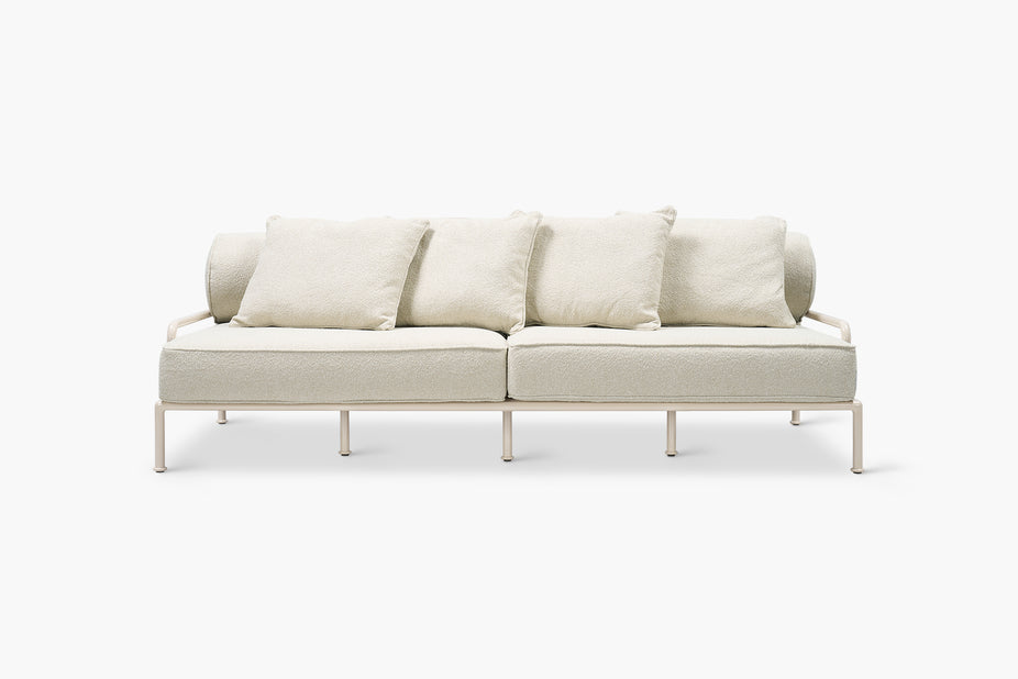 Cream boucle outdoor sofa with a glossy tan frame, front view