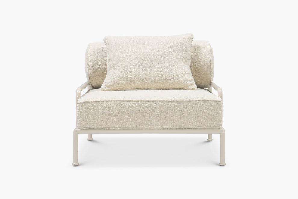 Cream boucle lounge chair with a glossy tan frame, front view