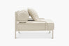 Cream boucle lounge chair with a glossy tan frame, side view