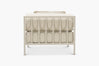 Cream boucle outdoor lounge chair with a glossy tan frame, rear view