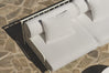 Close-up of white boucle cushions and slatted frame on stone patio