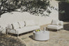 White boucle sofa and chair with coffee table under an olive tree