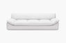 White sofa with plush seat and back cushions shown from the front in a studio.