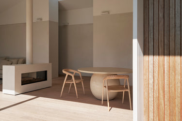 A modern dining chair made of ash timber, with a natural colour
