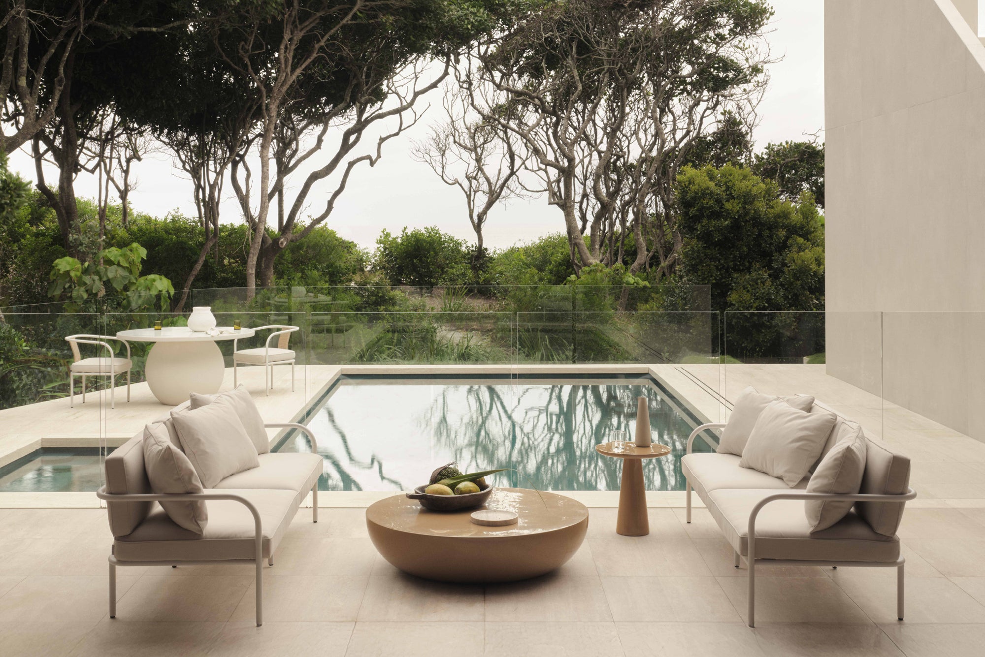 outdoor setting with white outdoor sofa and yellow coffee table