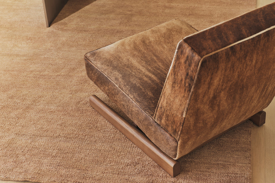 Brown leather Armchair on a textured brown surface