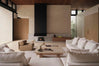 living room setting, white sofa, brown armchair , travertine coffee table