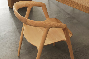 Wooden chair with a modern design on a concrete floor