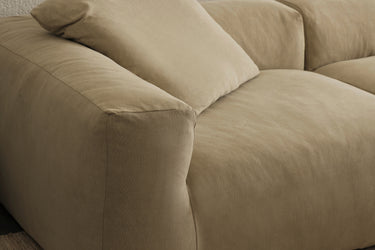 Close-up of taupe sofa cushion and armrest, side angle