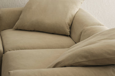 Close-up of taupe sofa back cushions with soft folded texture