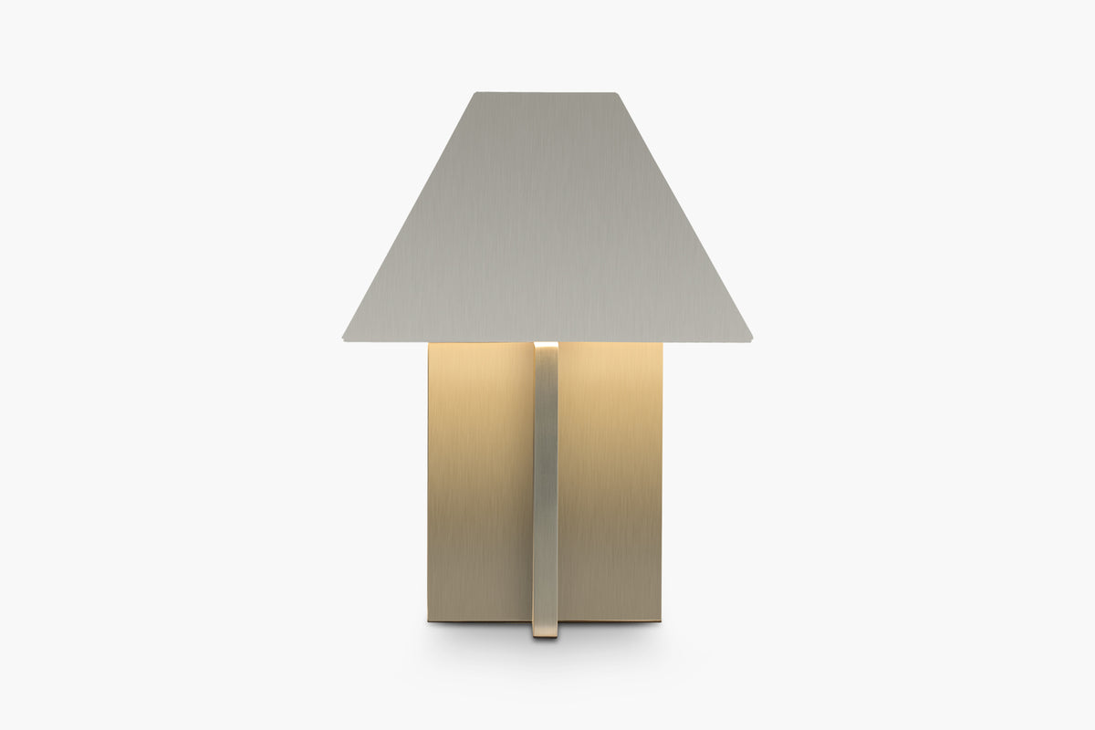 A brushed steel table lamp with a geometric design