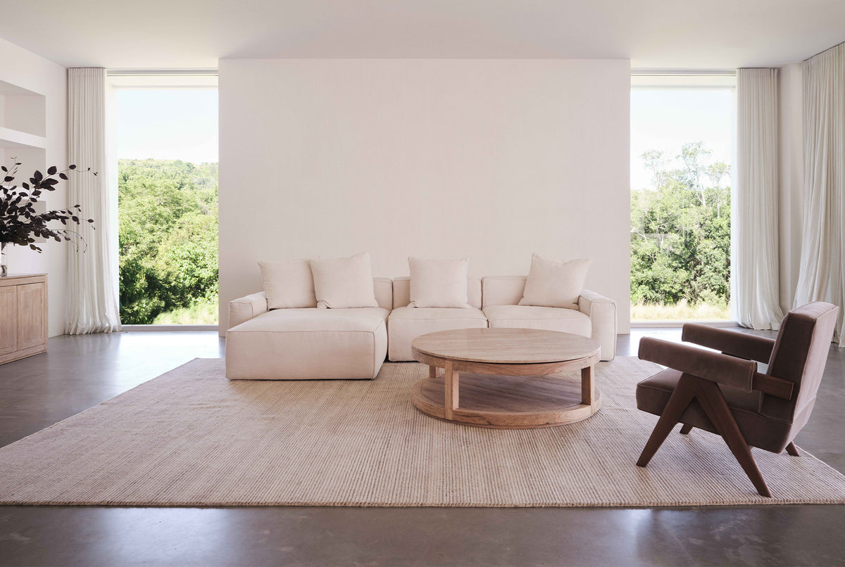 A round coffee table made of natural stone and old elm timber